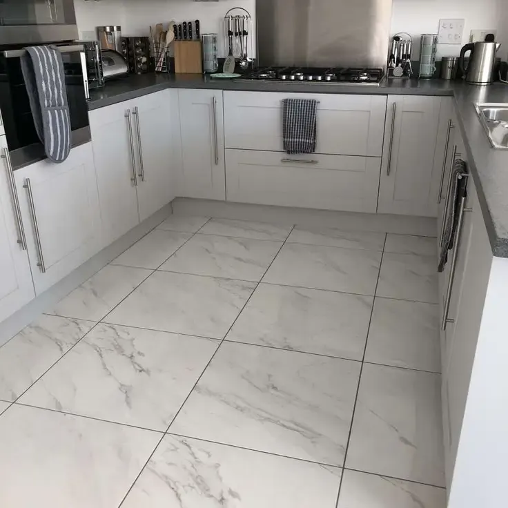 White kitchen with large marble-look porcelain floor tile