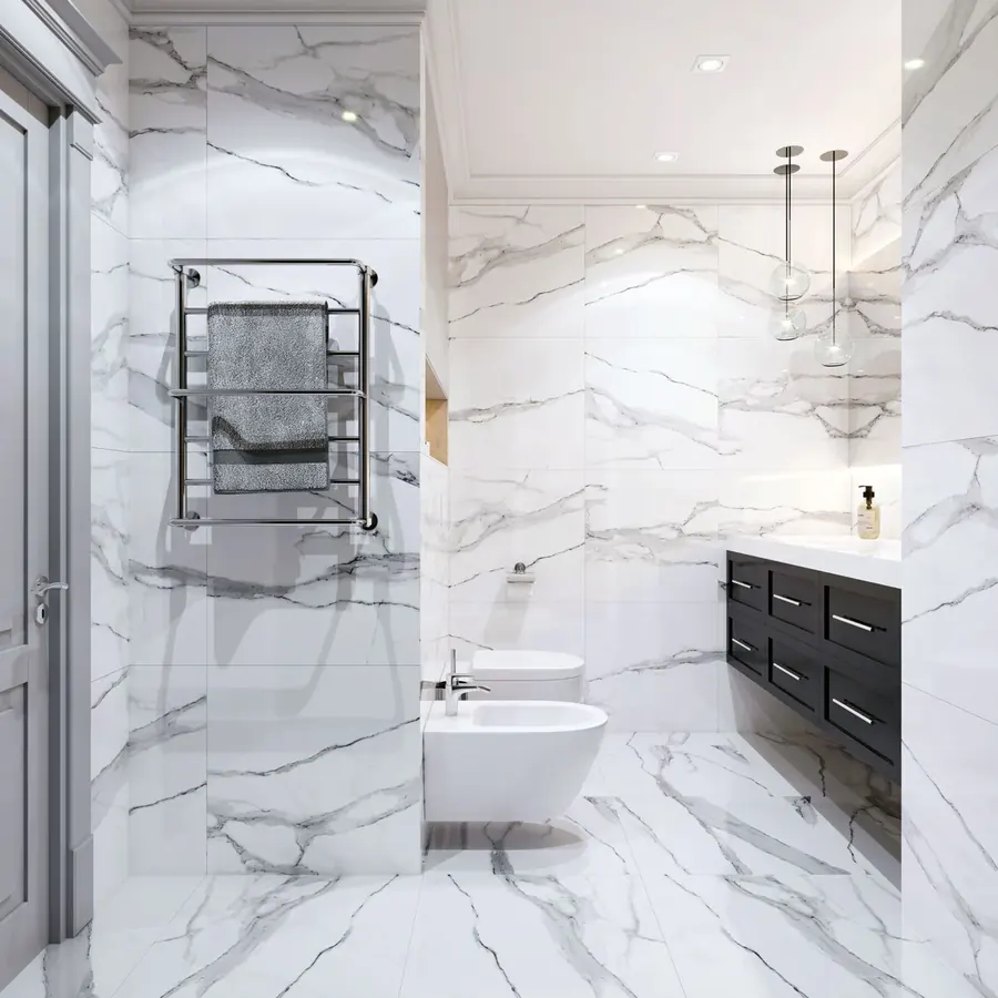 Bright marble-look tile bathroom with a heated towel rail