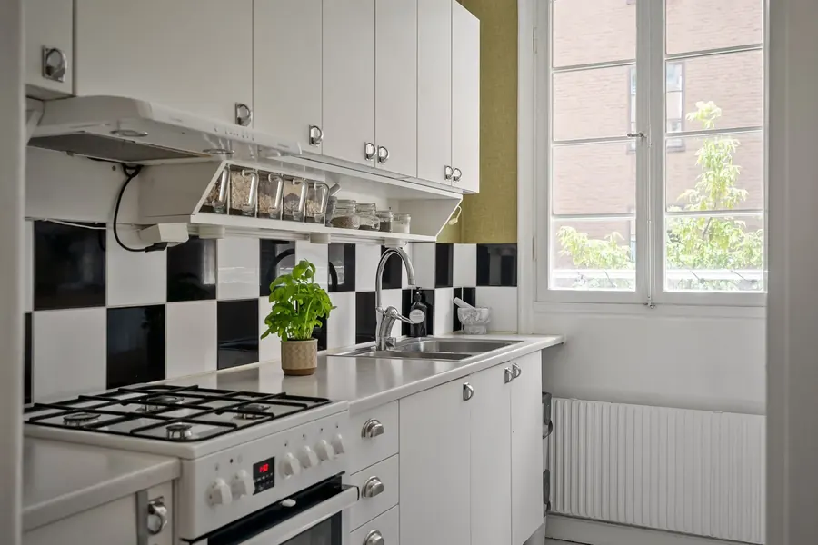 Kitchen with black and white checkerboard backsplash tile