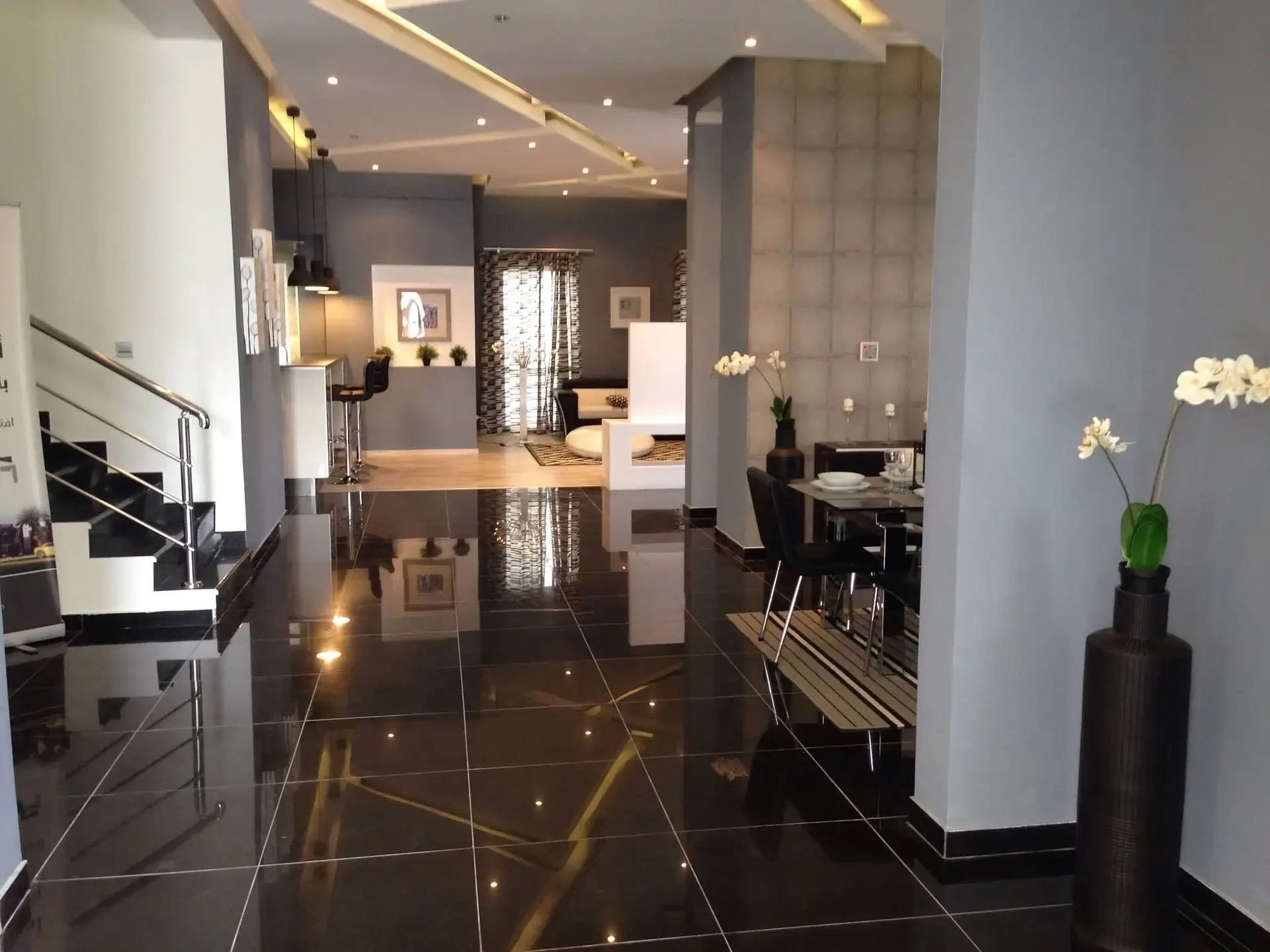 Polished black marble-look tile floor in a modern commercial lobby