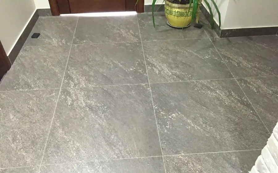 New gray stone-look porcelain floor after removal and prep